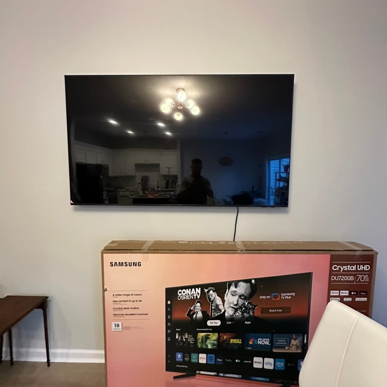 70-inch Samsung TV mounted flat on the wall with the cable run down out of the way